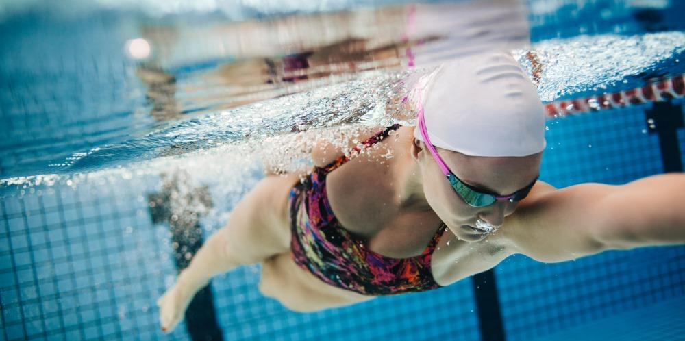 young female swimmer swimming in pool